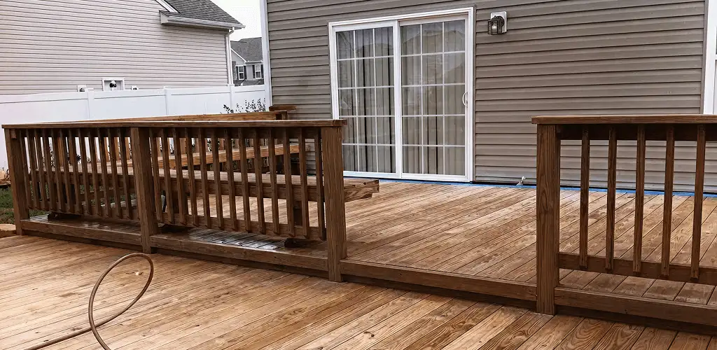 Deck sealing service protecting a backyard wood deck and railings in Fort Worth, TX