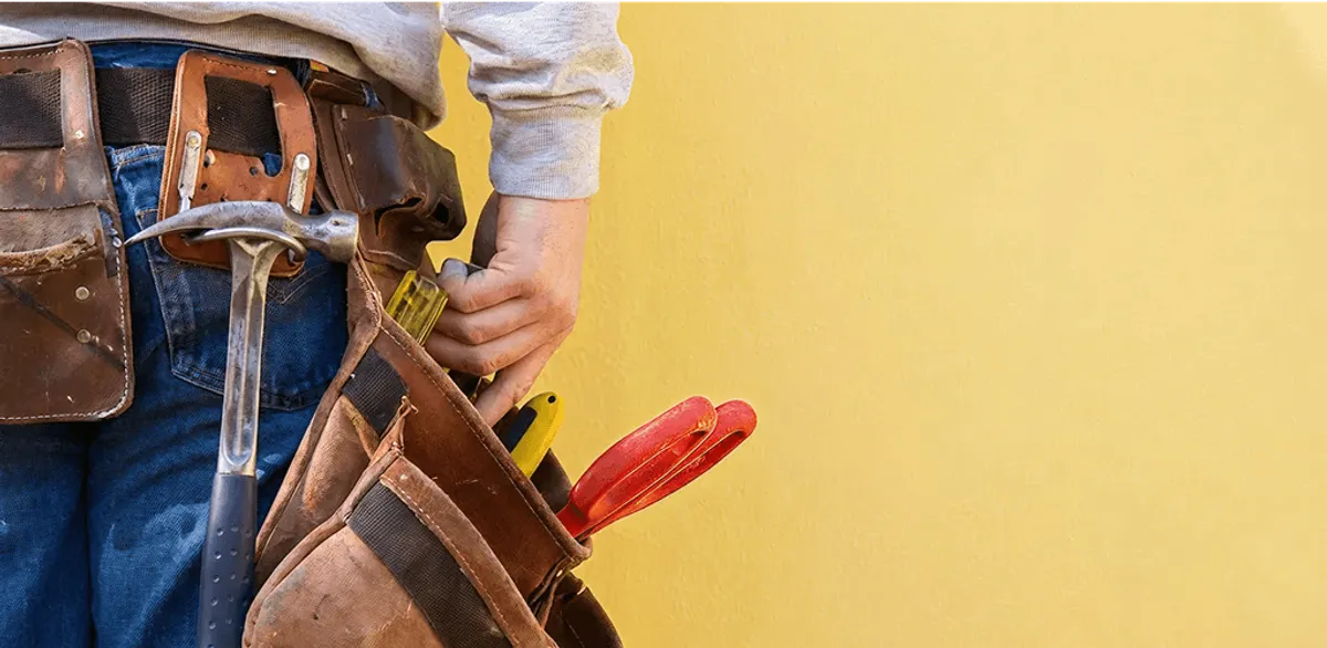 Handyman with tool belt ready for home repairs and maintenance in Fort Worth, TX