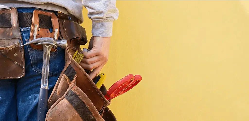 Handyman with tool belt ready for home repairs and maintenance in Fort Worth, TX