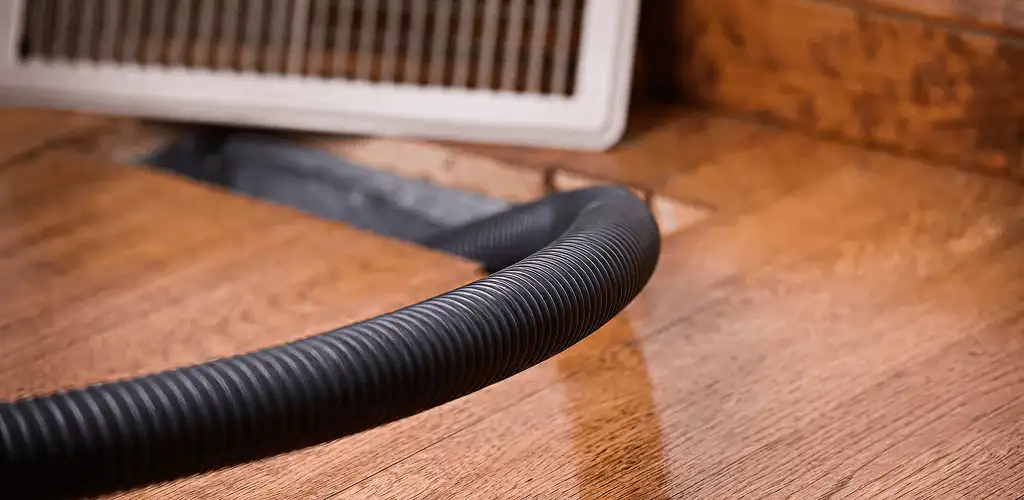Air duct cleaning hose inserted into a floor vent for ductwork cleaning in Fort Worth, TX