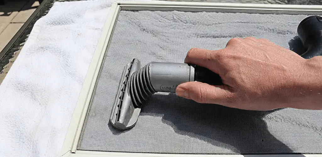 Window screen repair cleaning and fixing a damaged screen mesh in Fort Worth, TX